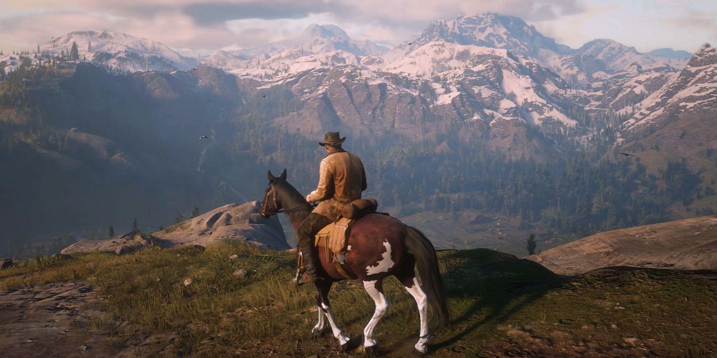 Arthur stands in front of some mountains