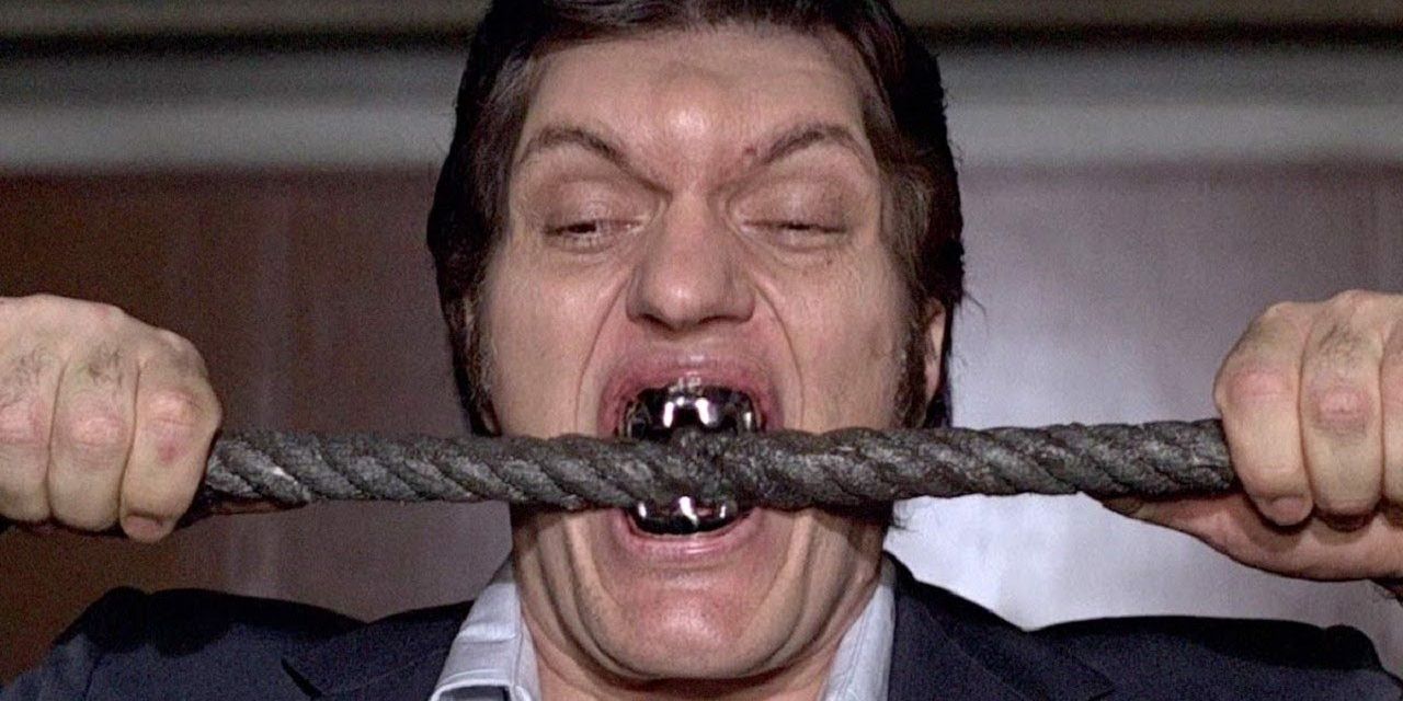 Richard Kiel as Jaws biting a cable in James Bond