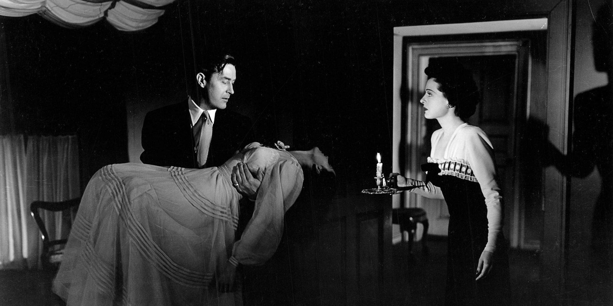 Roderick holding Stella as Pamela looks on in The Uninvited (1944)