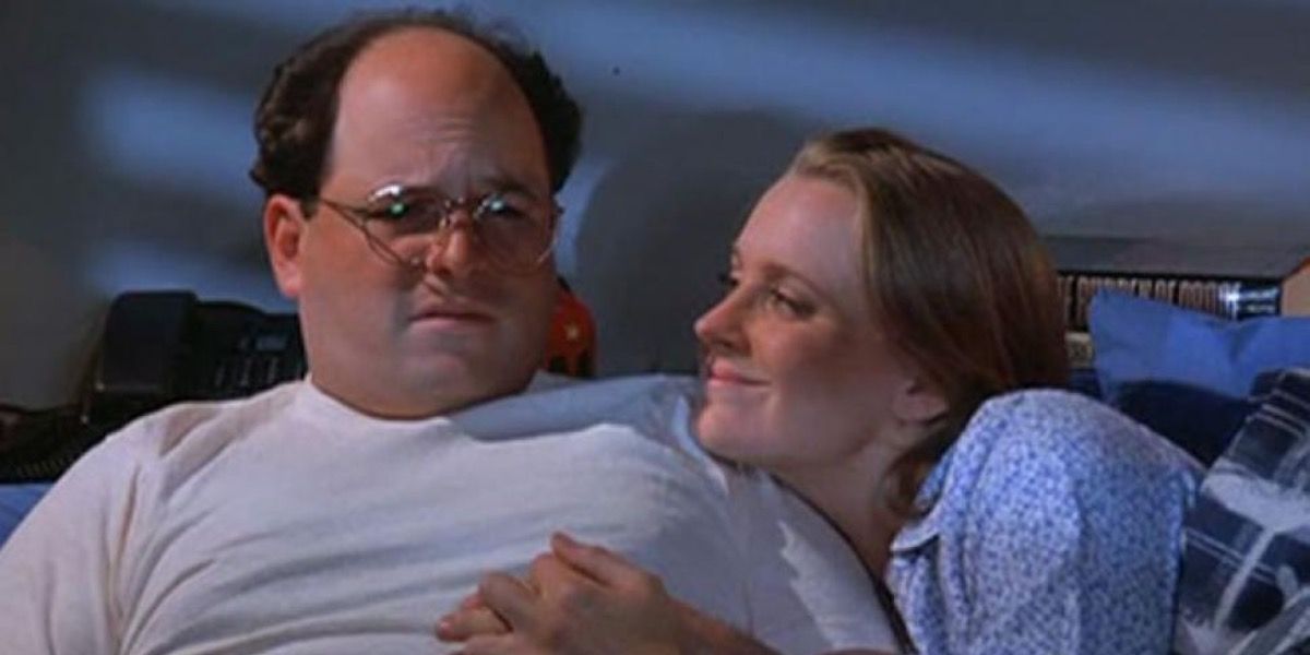 George looking upset lying in bed with Susan on Seinfeld