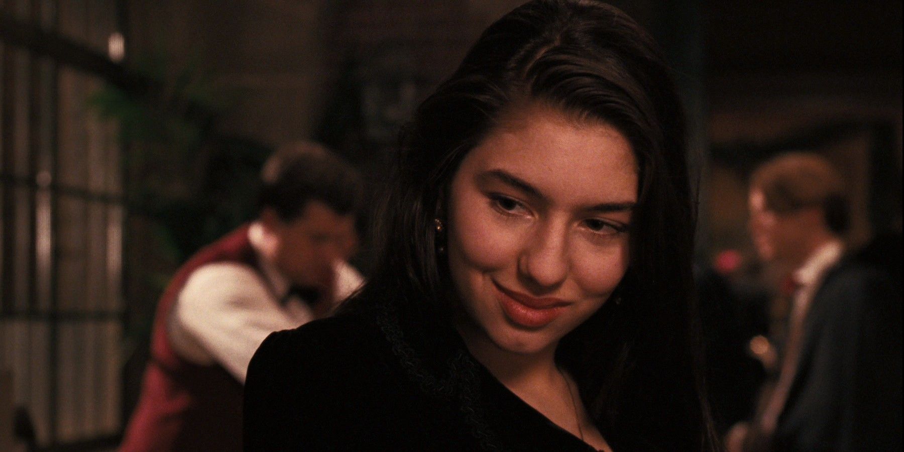 Sofia Coppola grinning as Mary Corleone in The Godfather Part III.