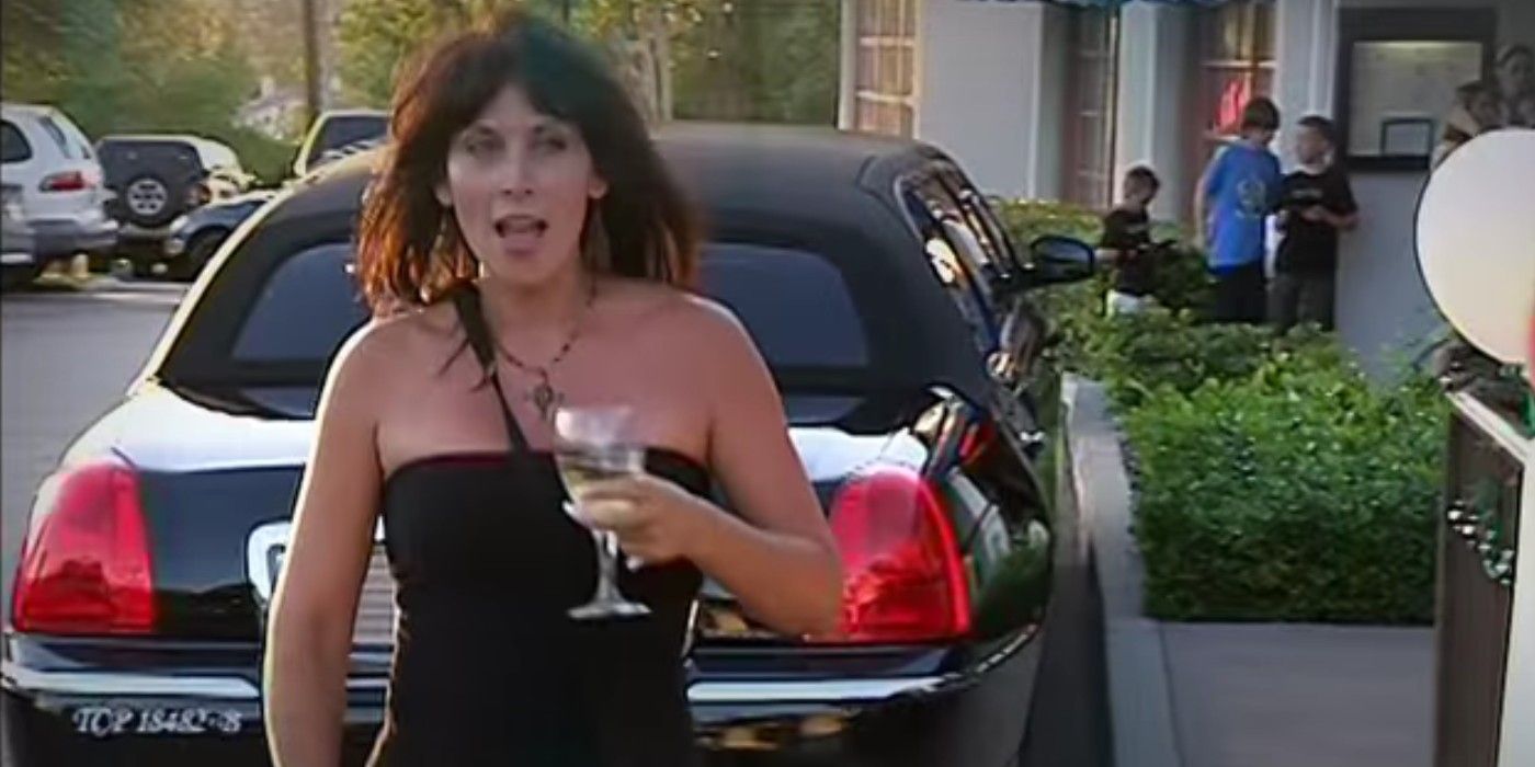 Tammy Knickerbocker holding a glass of wine on RHOC
