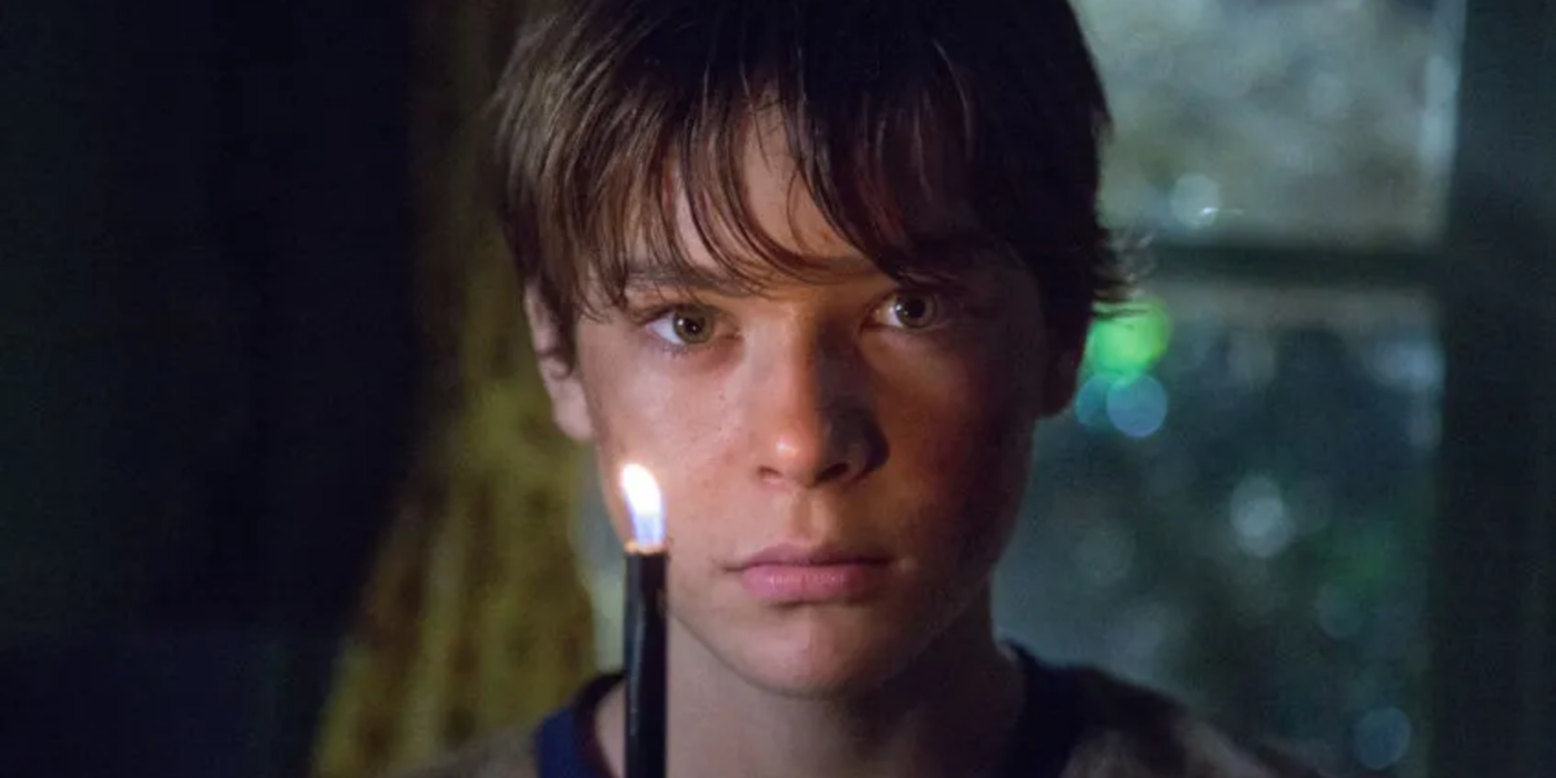 Judah Lewis's Cole holding a lighter in The Babysitter