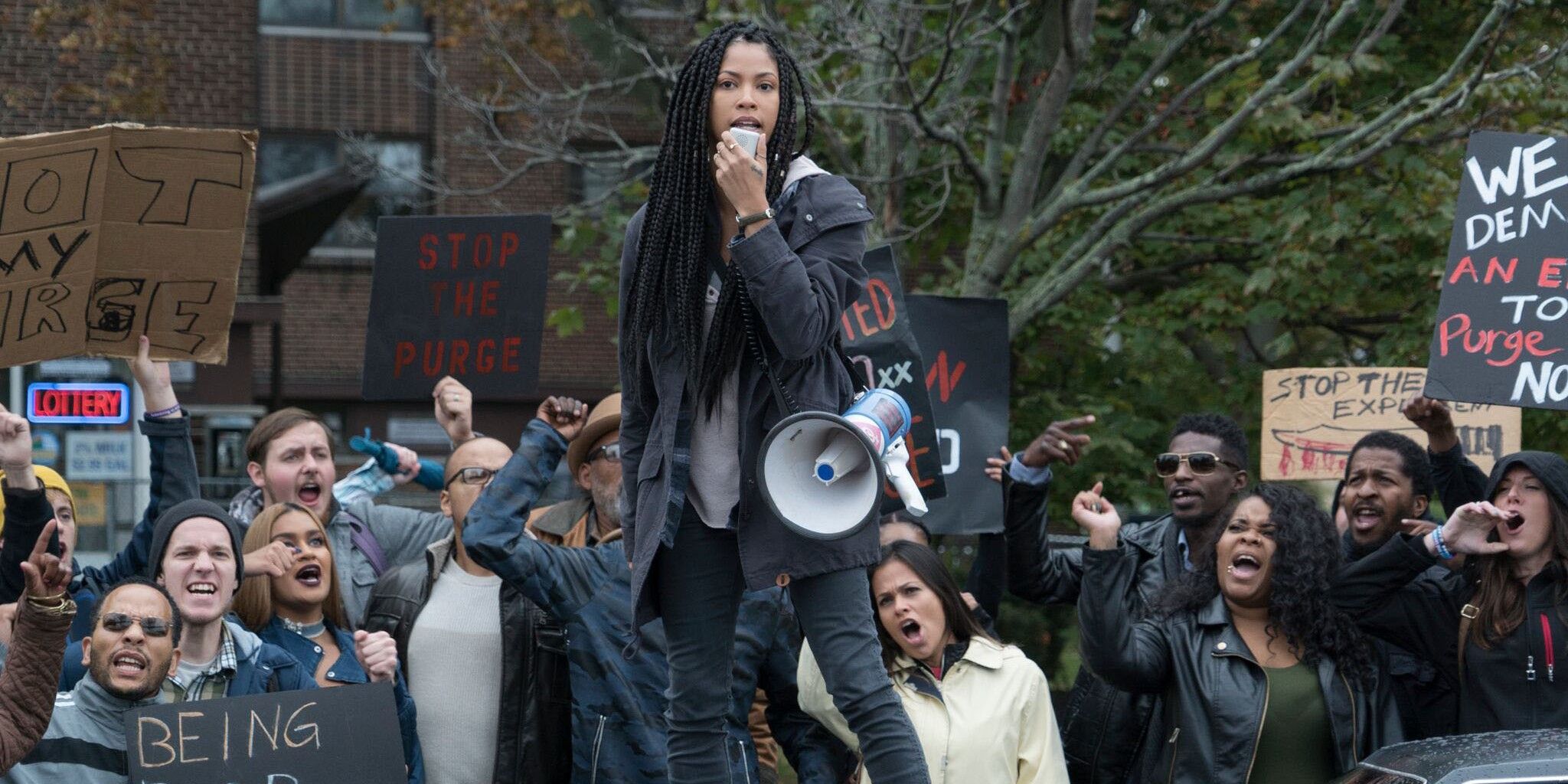 A woman leads a protest in The First Purge