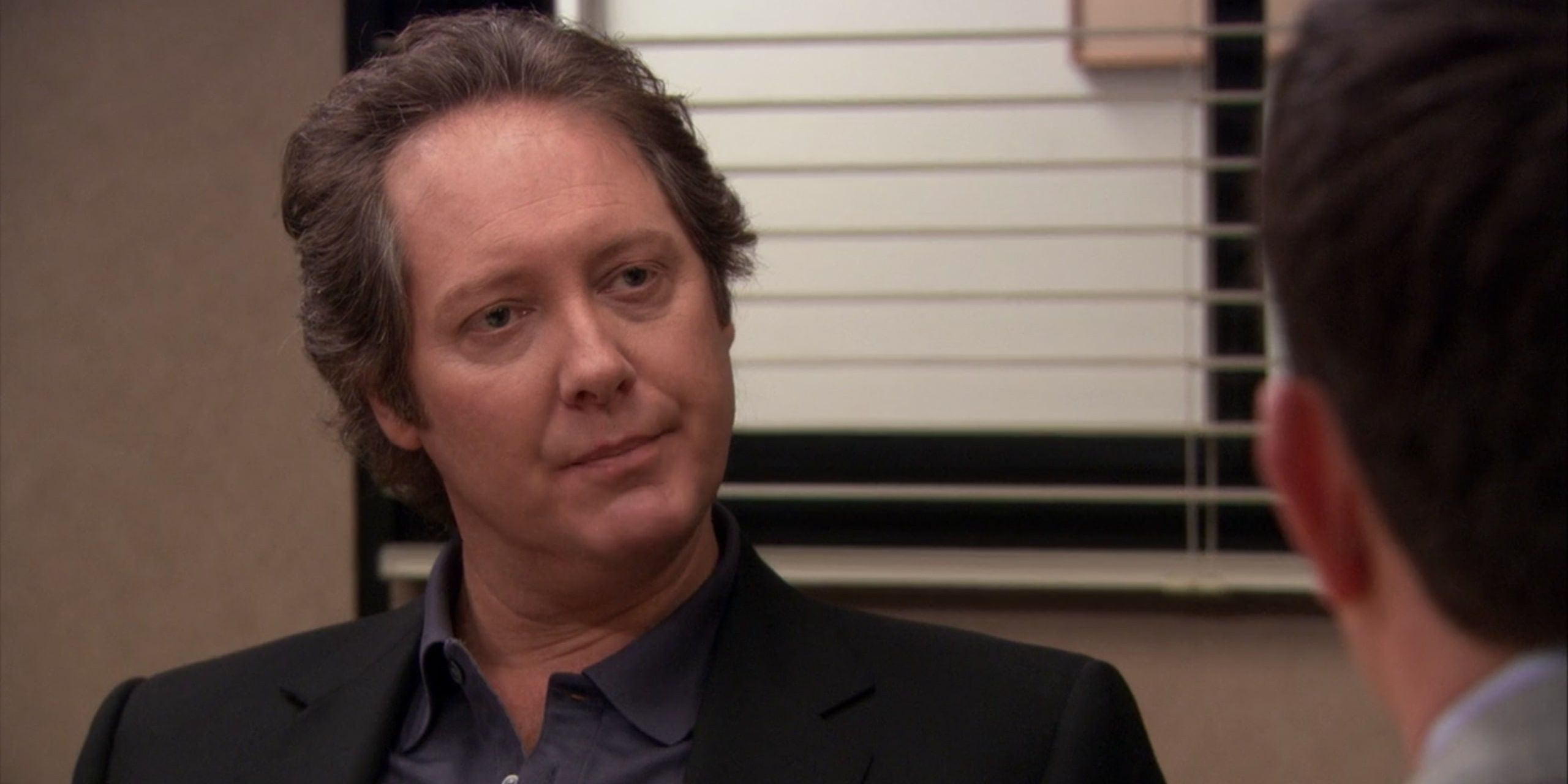 Robert California staring at Jim in interview in The Office