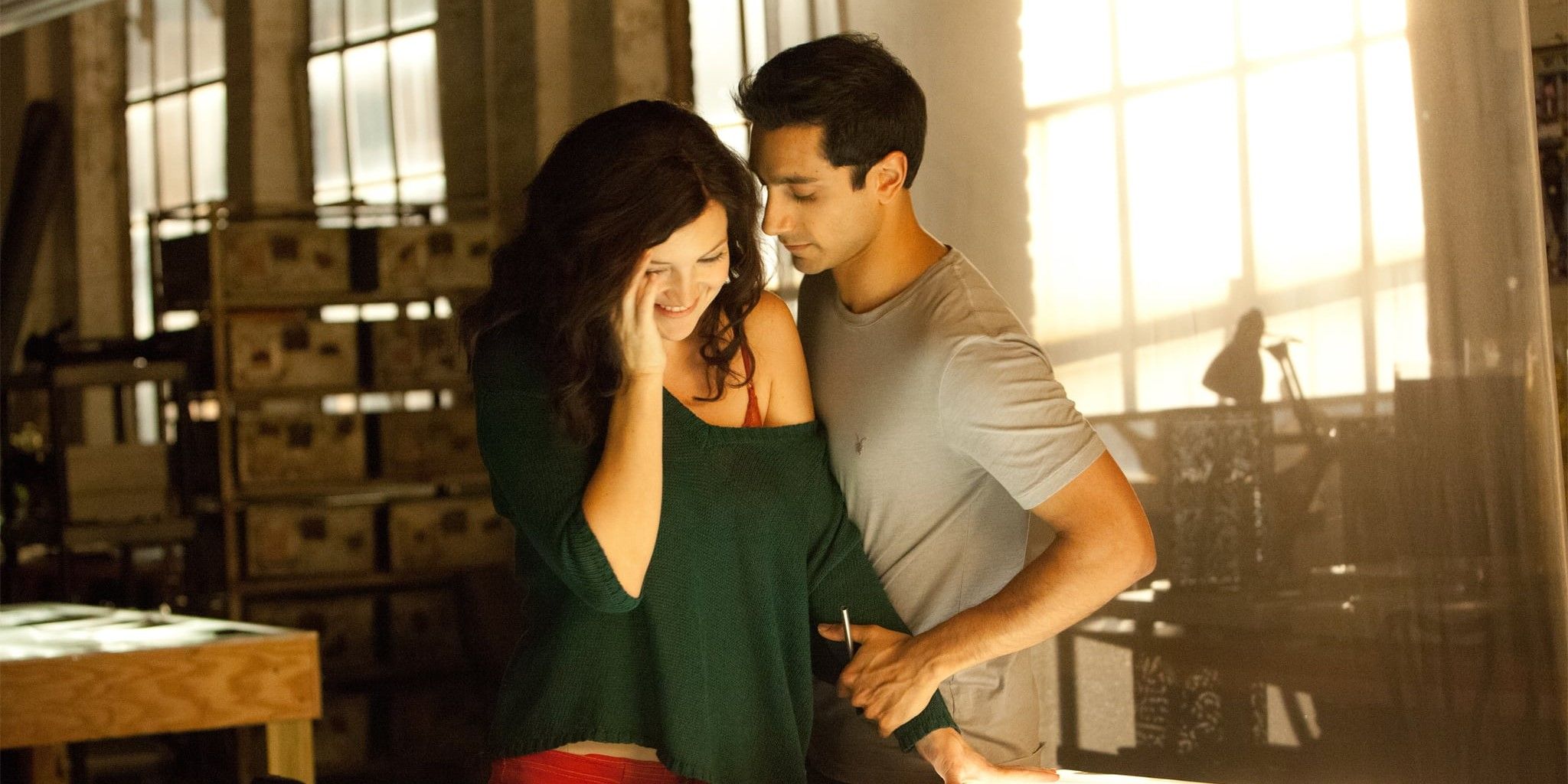Riz Ahmed standing next to a woman and holding her arm in a still from The Reluctant Fundamentalist