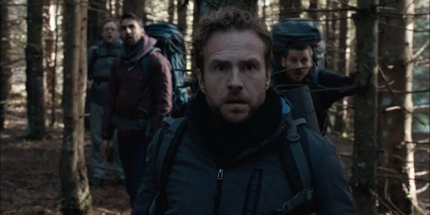 Luke looking scared in the woods in The Ritual