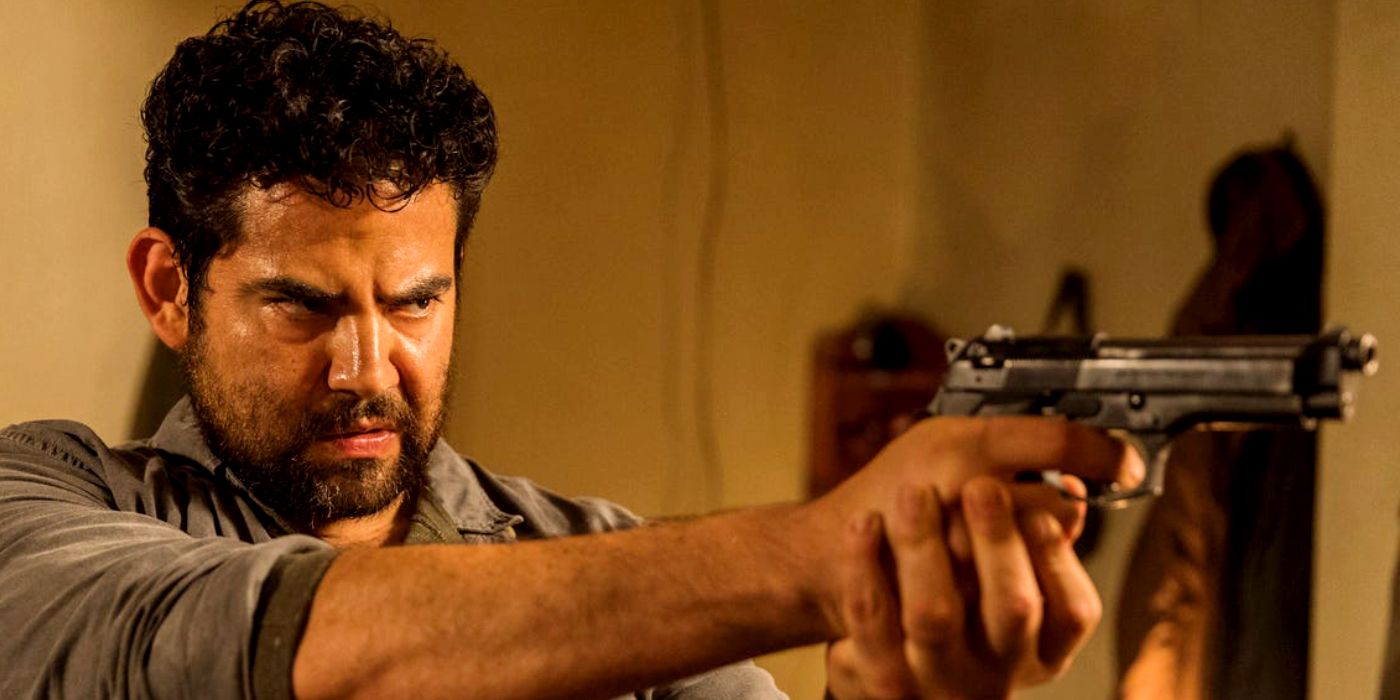 Morales returns and points a gun at Rick in The Walking Dead
