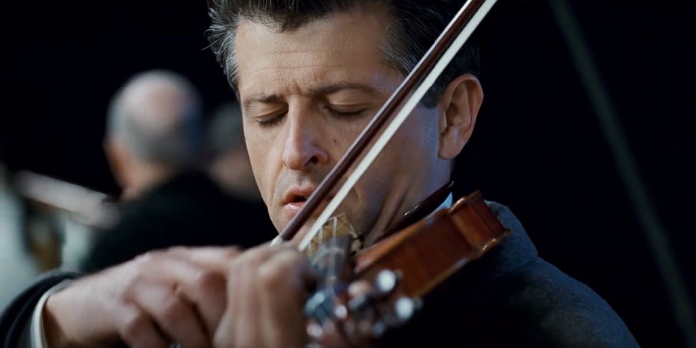 A musician playing the violin while the Titanic sinks.