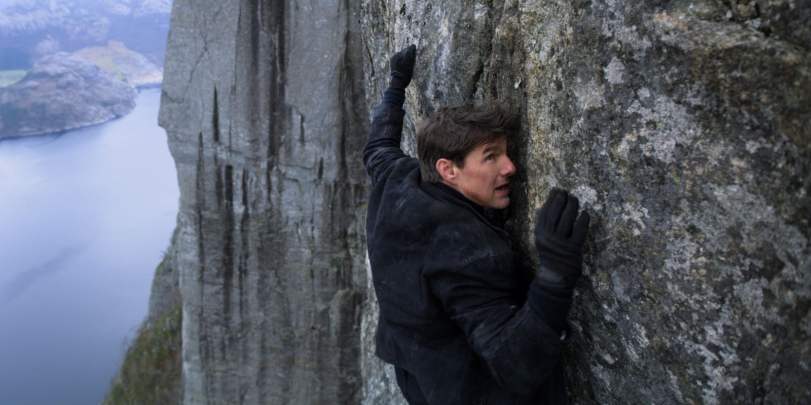 Tom Cruise hanging from a cliff in Mission Impossible Fallout