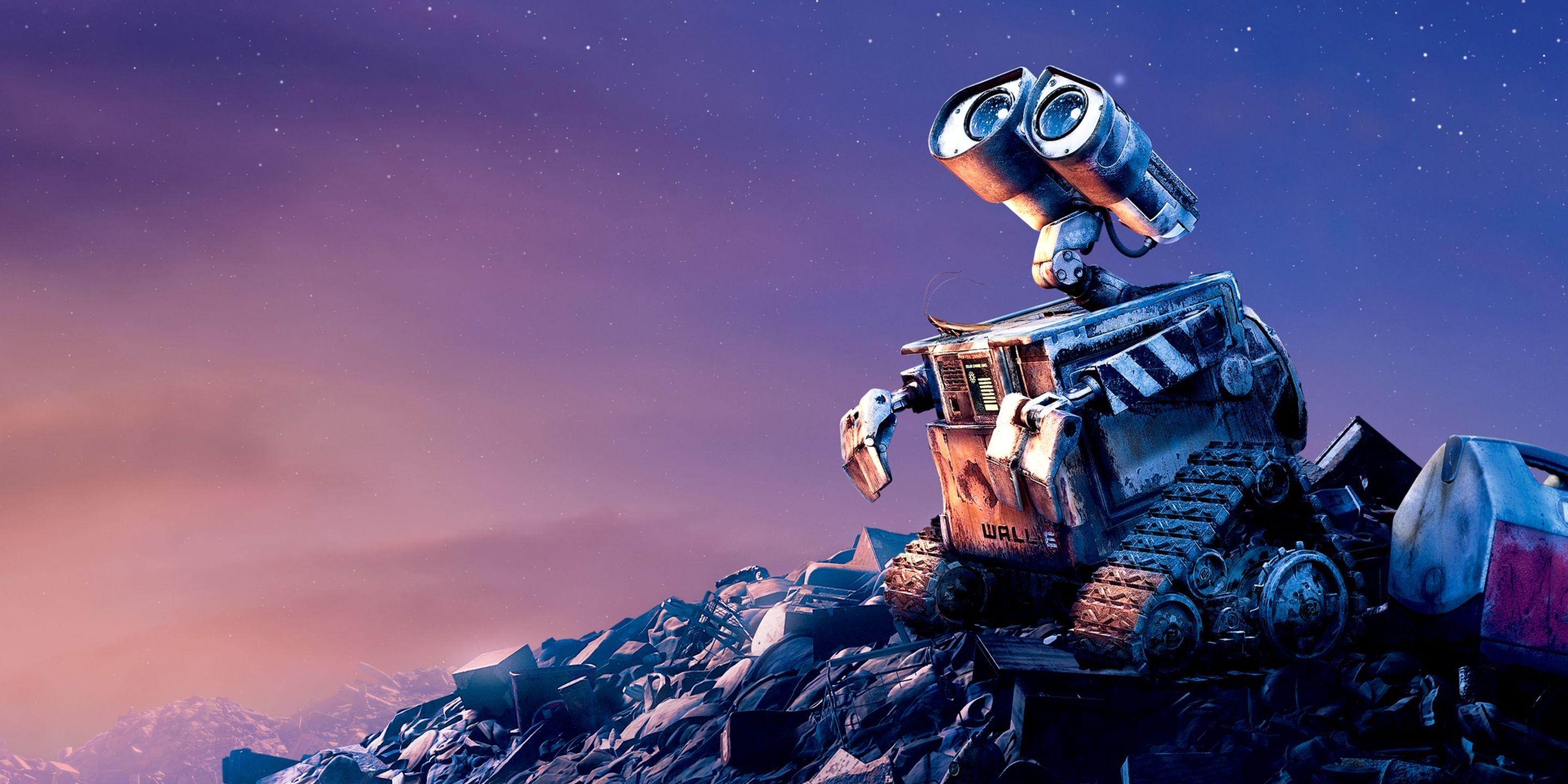 WALL-E sitting on a pile of rubbish, looking at the sky