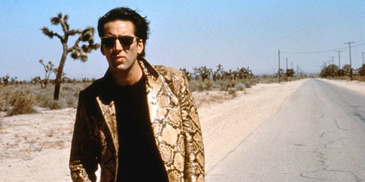 Nicholas Cage walking down the road in Wild at Heart