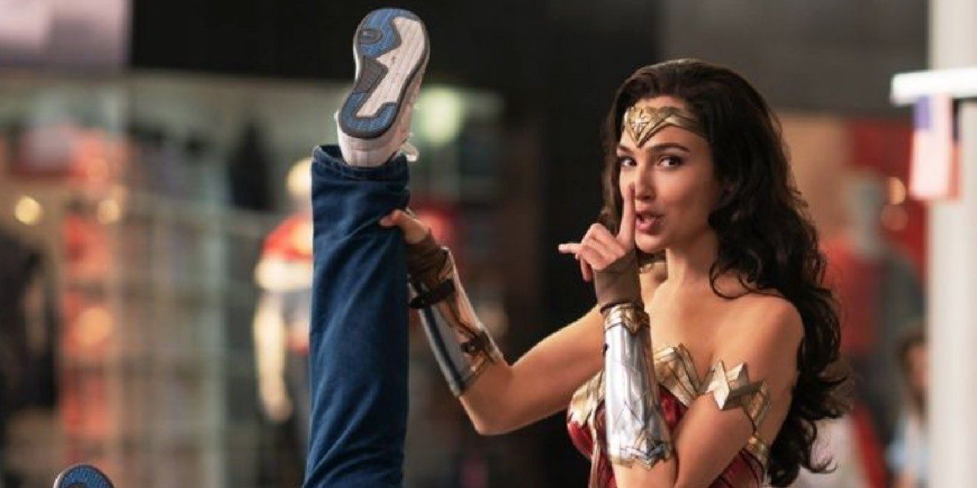 Gal Gadot as Wonder Woman holding up a criminal&rsquo;s leg