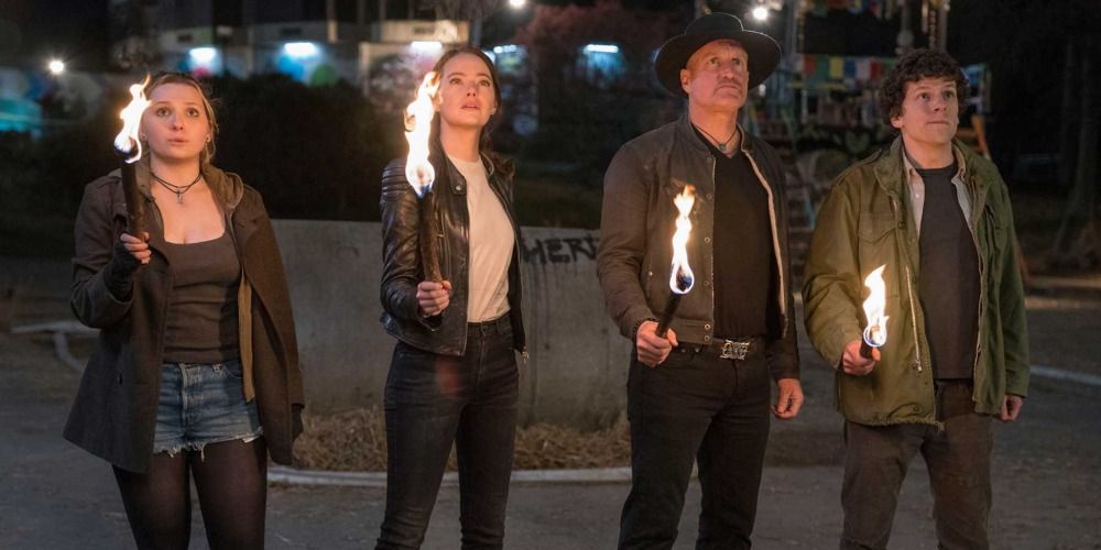 Little Rock, Wichita, Tallahasse, and Columbus holding torches in Zombieland: Double Tap
