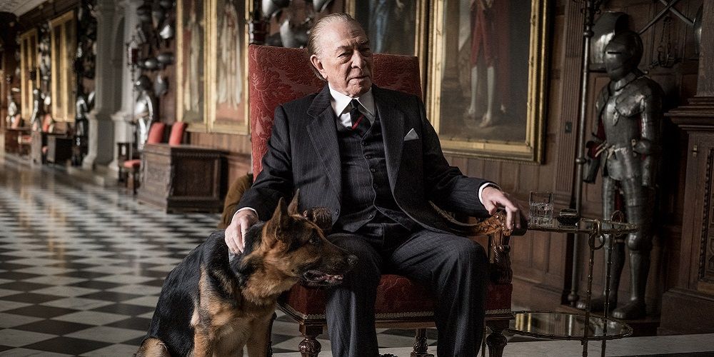 Paul Getty strokes a dog in a mansion in All the Money in the World