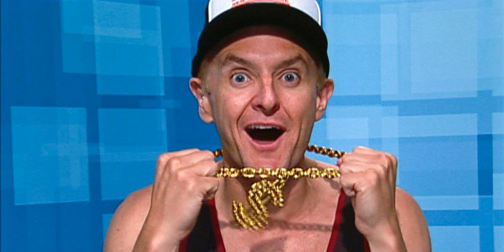 Mike Malin from Big Brother in the diary room, holding up the Veto necklace with his mouth open in excitement.