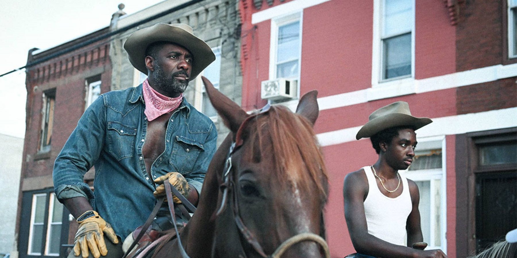 Idris Elba and Caleb McLaughlin riding horses in the 2020 Western Concrete Cowboy, which is available on Netflix.