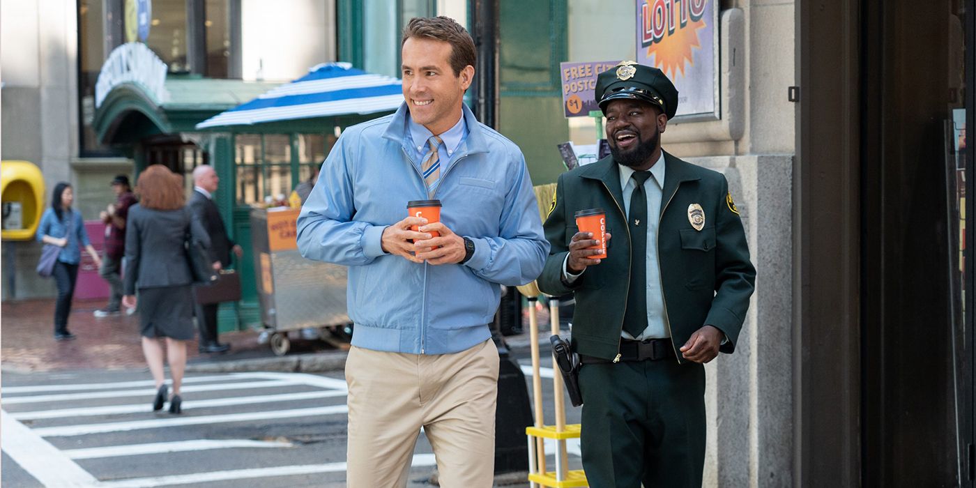 Ryan Reynolds and Lil Rel Howery walking down the sidewalk in Free Guy.