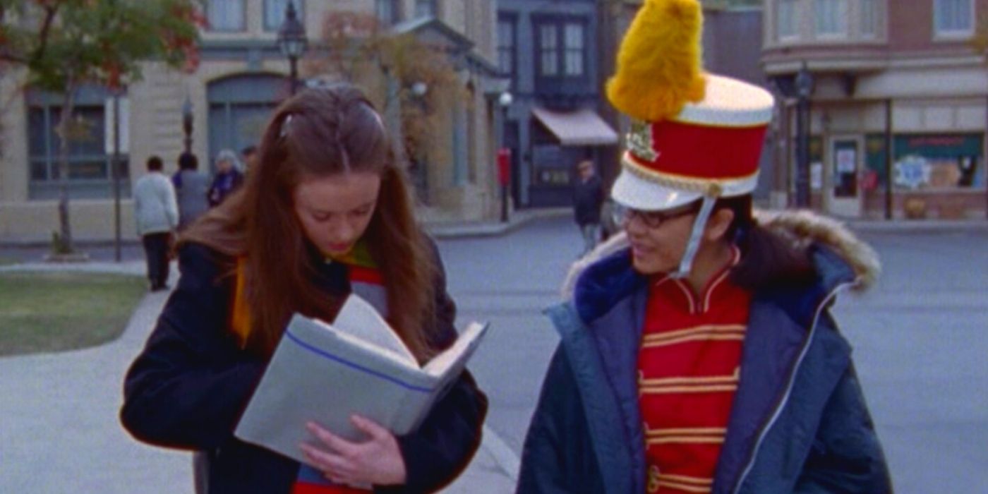 Rory reading a book standing with Lane in her school band uniform on Gilmore Girls.