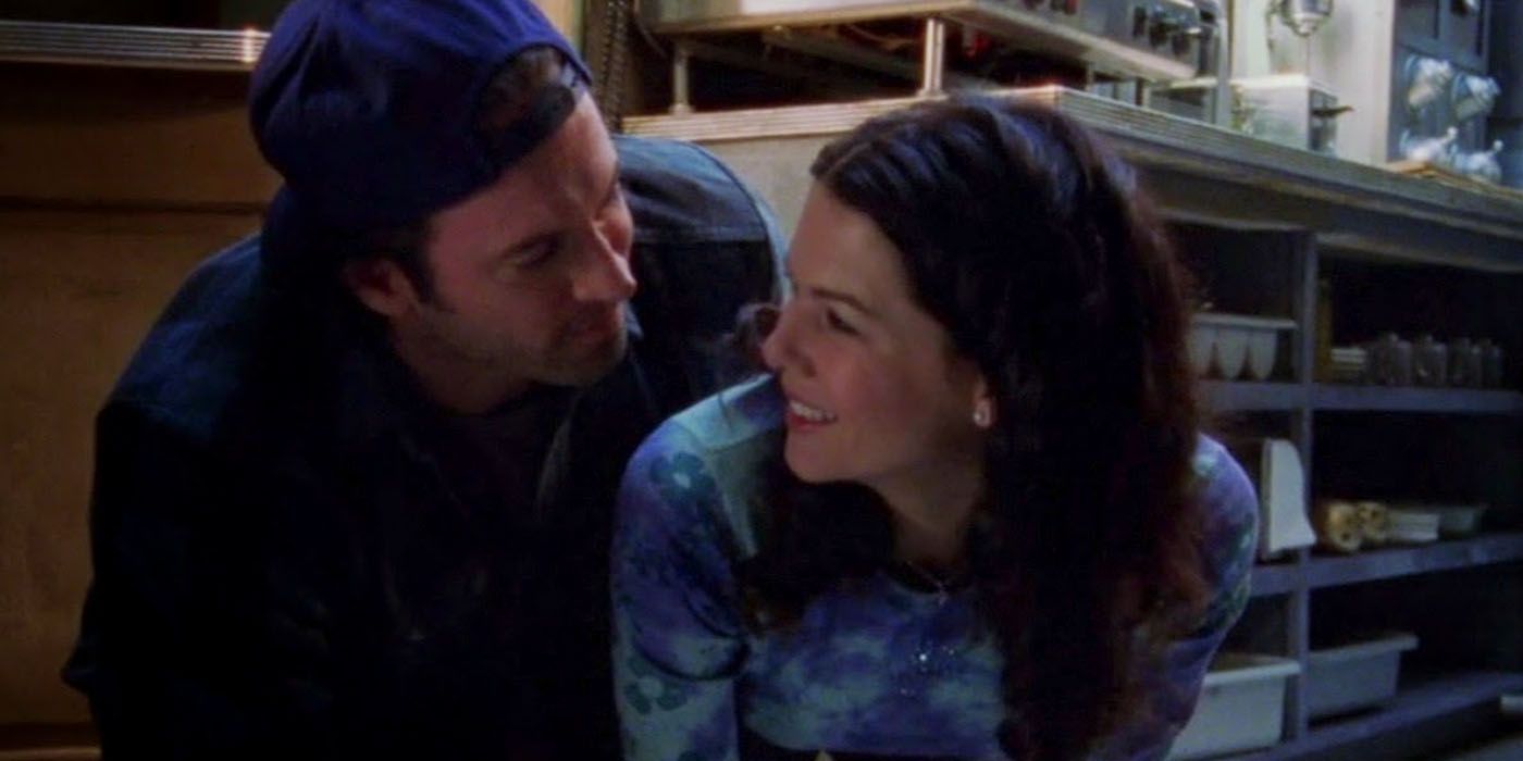 Luke and Lorelai leaning behind the counter at the diner on Gilmore Girls