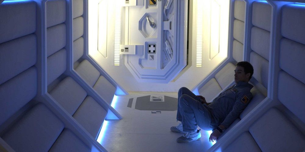 Sam sitting in his ship in Moon (2009).