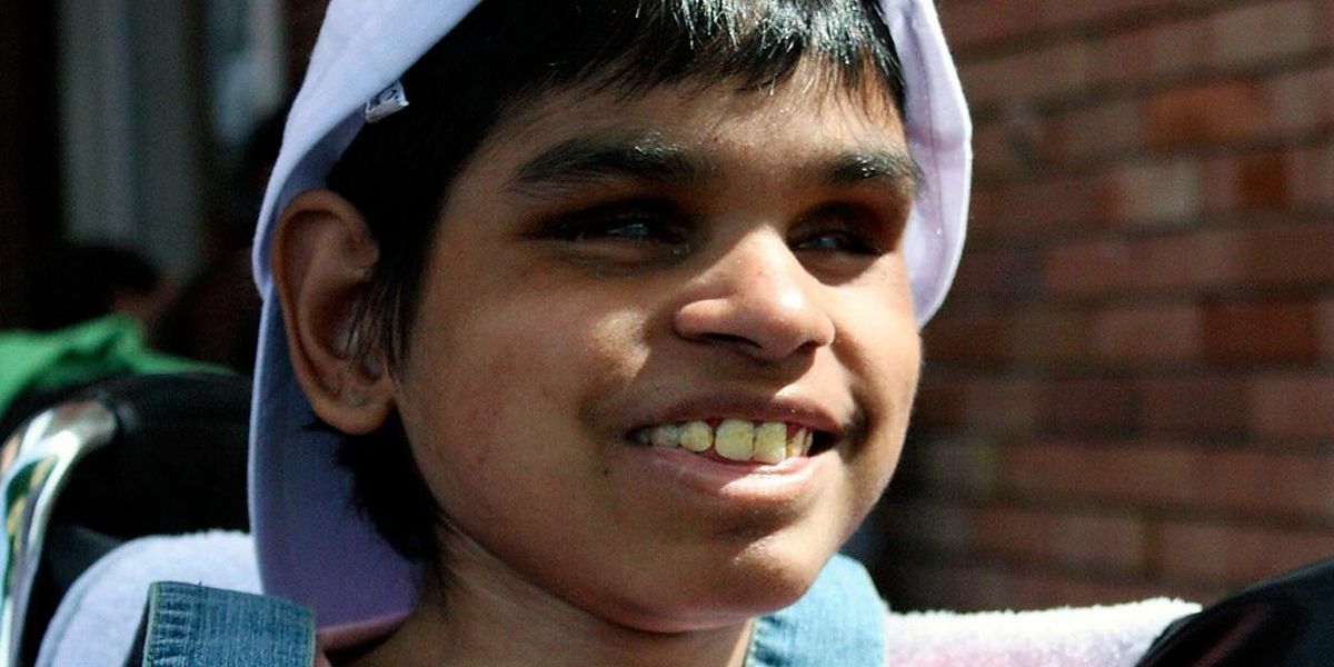 smiling child with backwards baseball cap