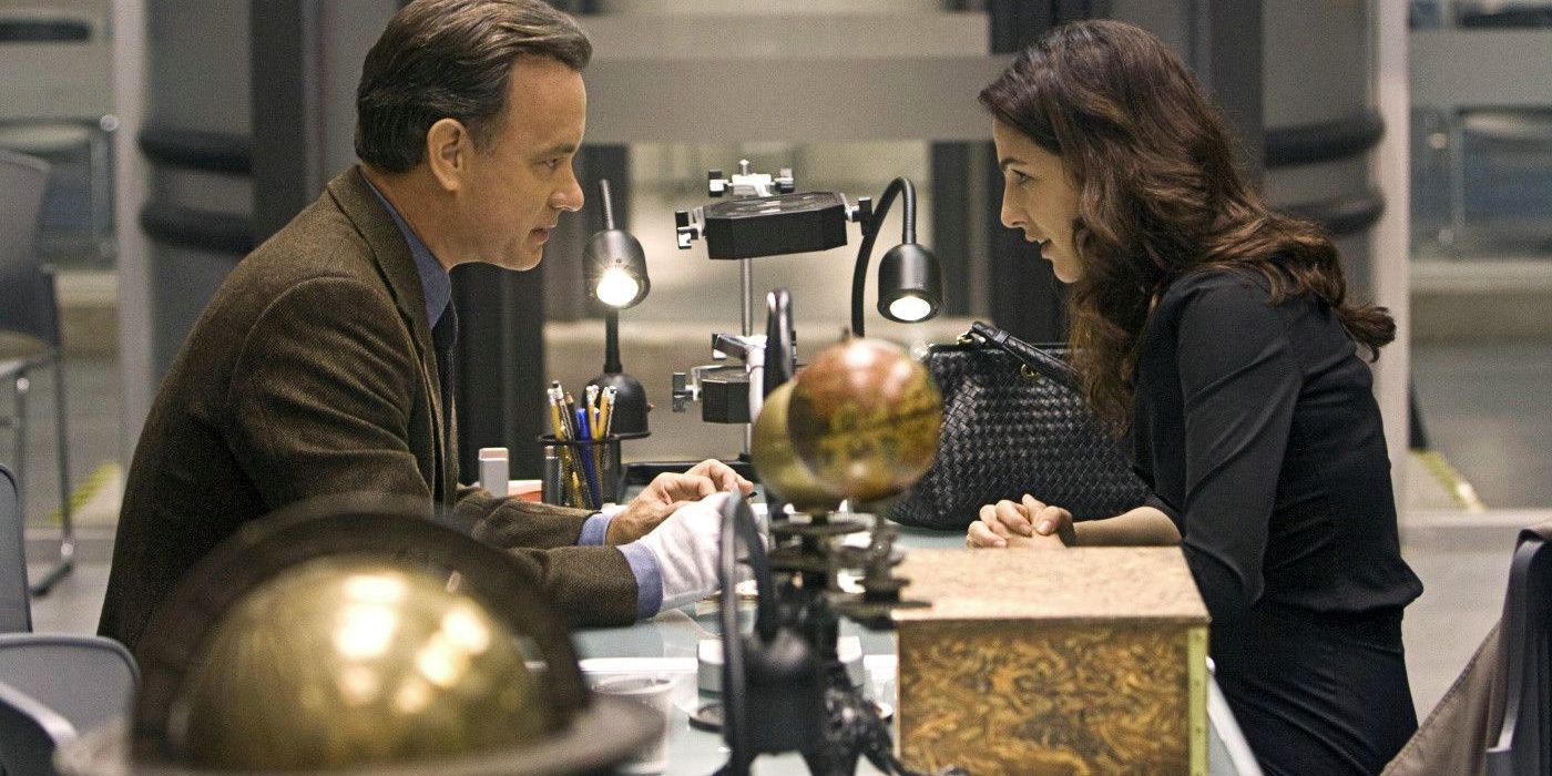 Langdon sits at a desk surrounded by globes in Angels and Demons