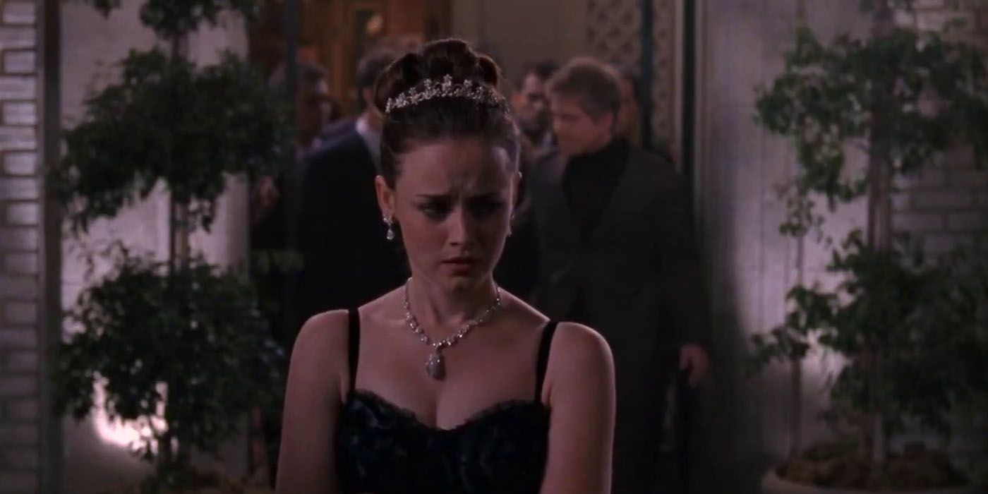 Rory appears sad in formal wear at a party in Gilmore Girls