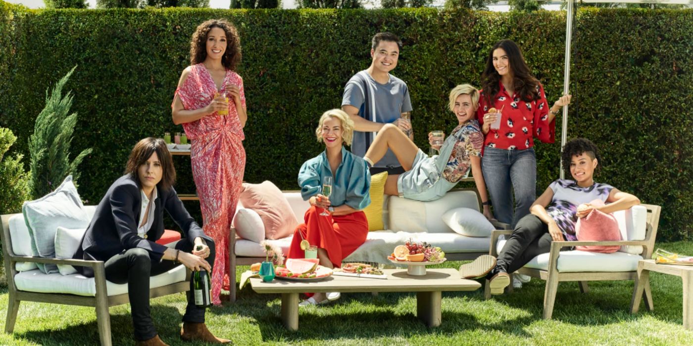 All the cast members of The L Word: Generation Q posing on a lawn with champagne