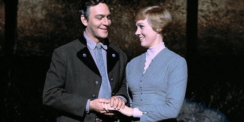 Christopher Plummer and Julie Andrews as Captain and Maria on stage and holding hands in The Sound of Music
