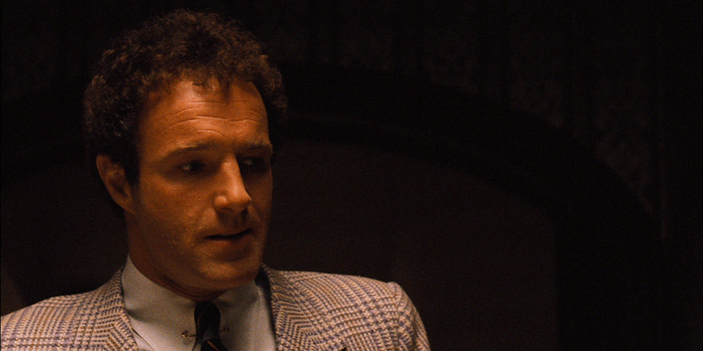 Sonny Corleone looks at something from behind the camera in The Godfather.