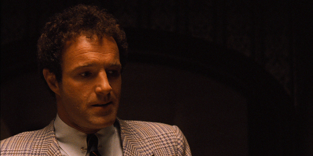 Sonny Corleone looking intently at something off-camera in The Godfather.