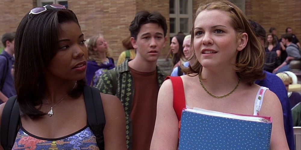 Gabrielle Union as Chastity in a printed top and backpack and Larisa Oleynik with books in hand on 10 Things I Hate About You