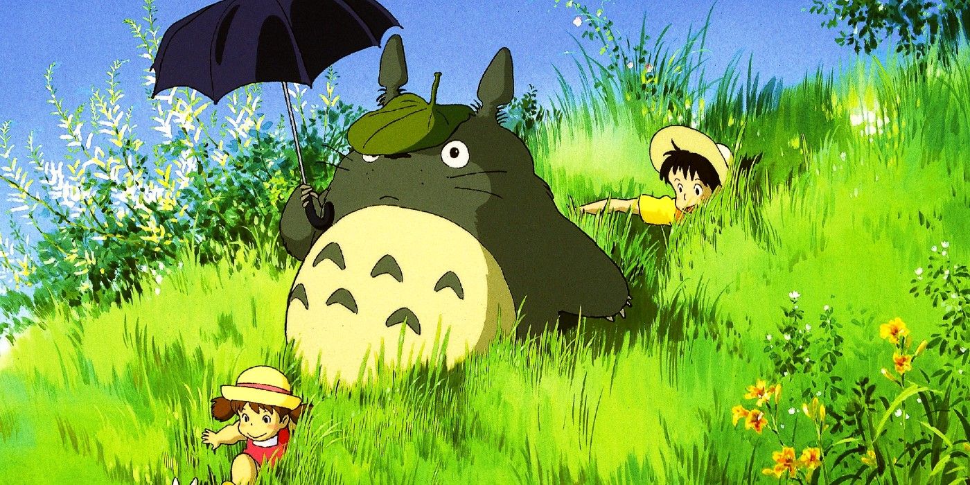 Totoro walks in a field with two girls and carries an umbrella in My Neighbor Totoro.