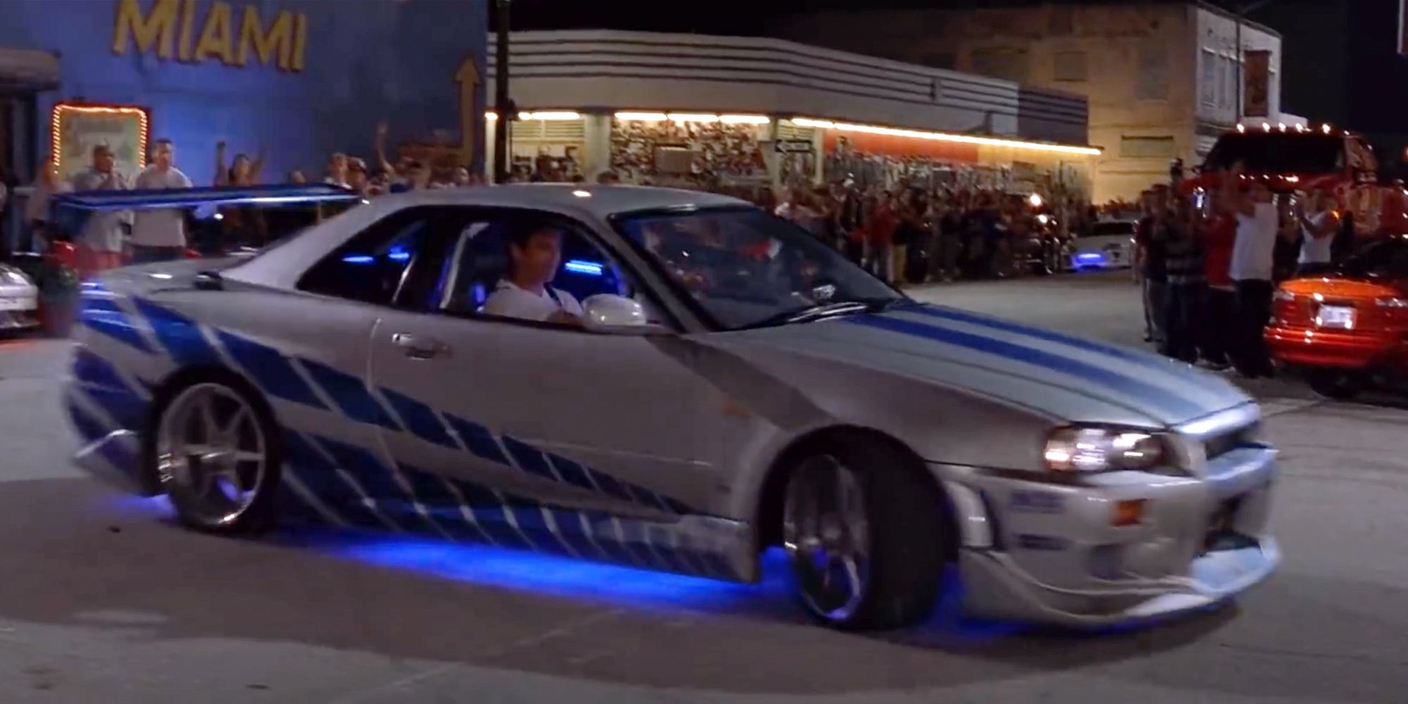 Brian driving a blue and silver Nissan Skyline in 2 Fast 2 Furious