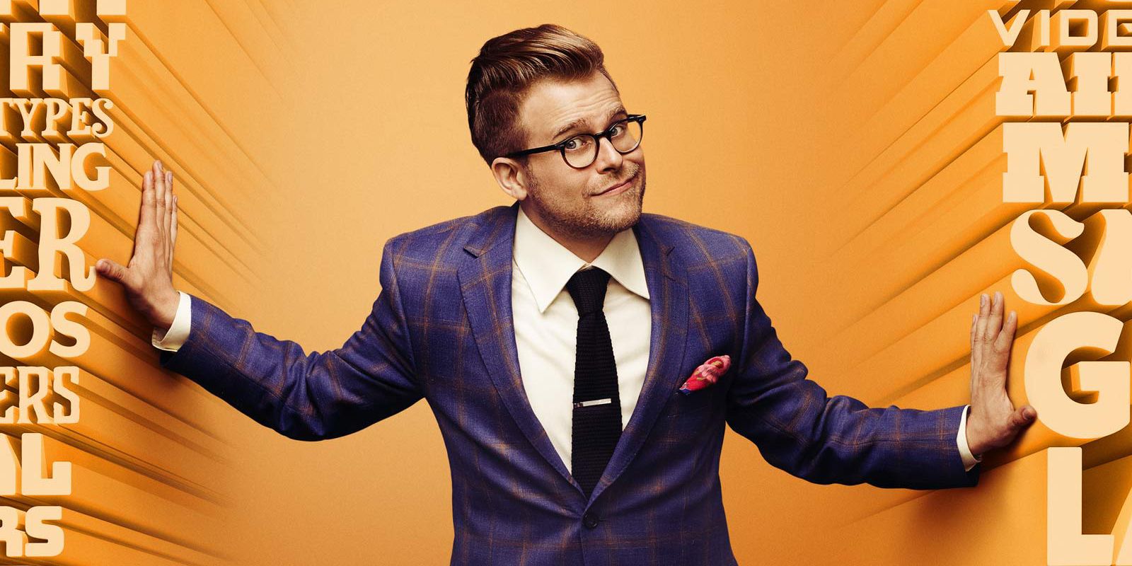 Adam pushes words aside to appear on a title for Adam Ruins everything.