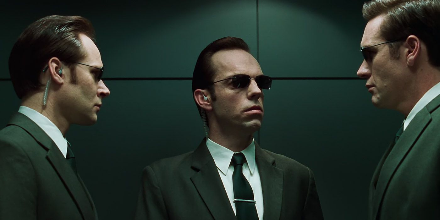Agent Smith talks with two other agents about Cypher's failed mission in The Matrix