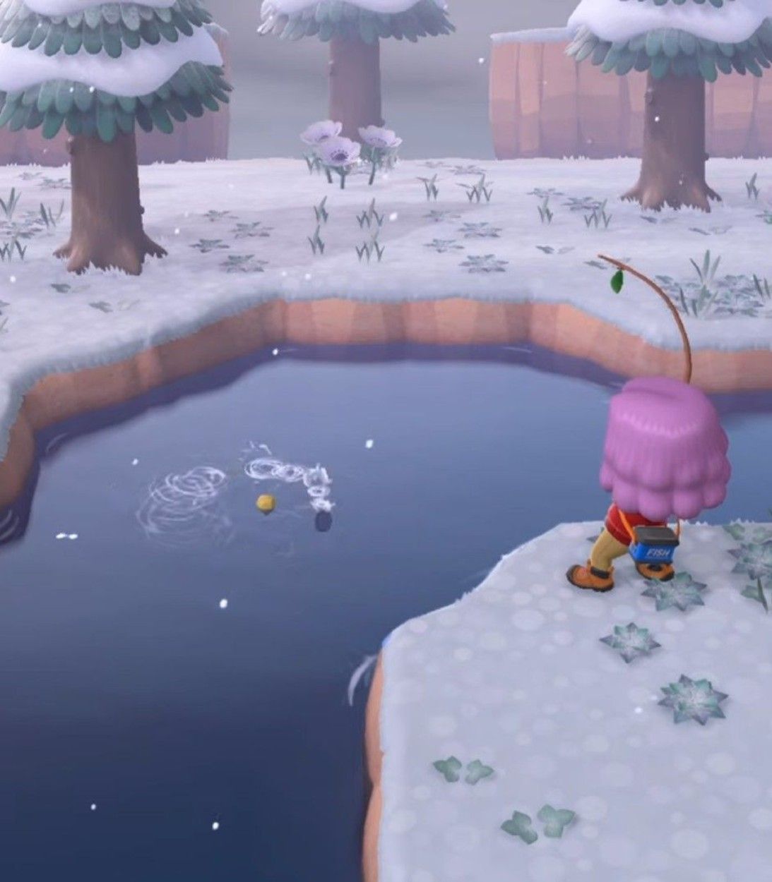 A player fishes in the river off a snowy bank in Animal Crossing: New Horizons