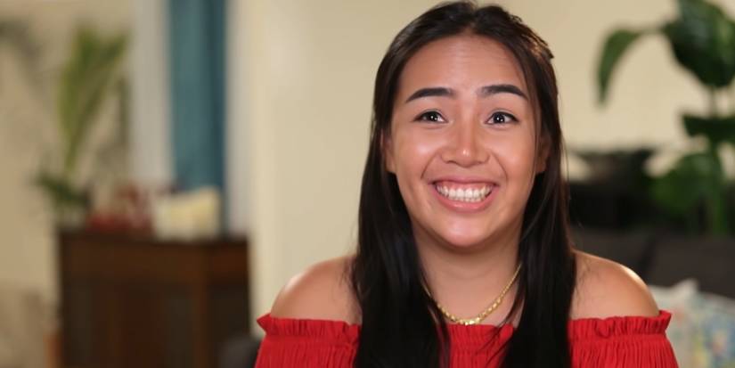 Annie Suwan In 90 Day Fiance smiling in red off-shoulder dress