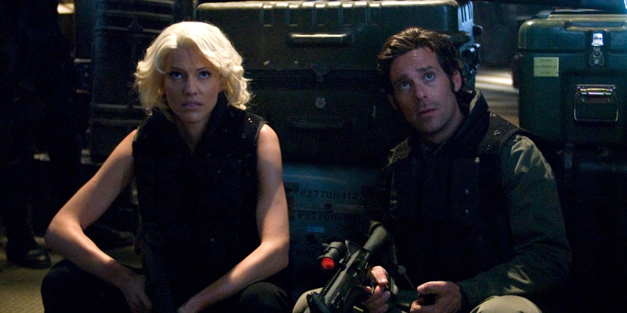Two characters in Battlestar Galactica look up at something off camera.