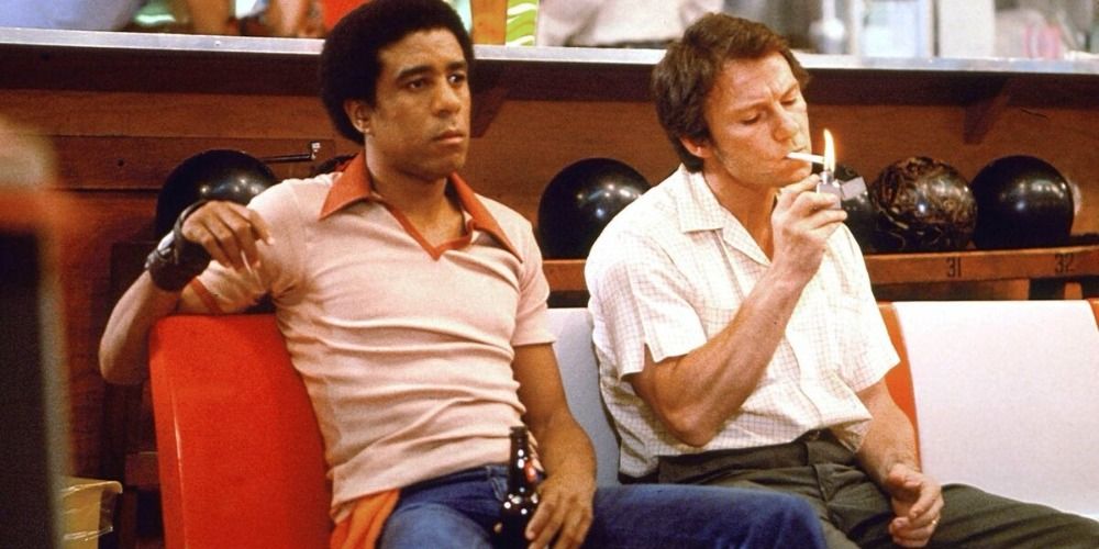 Zeke and Jerry sitting next to each other and smoking in Blue Collar