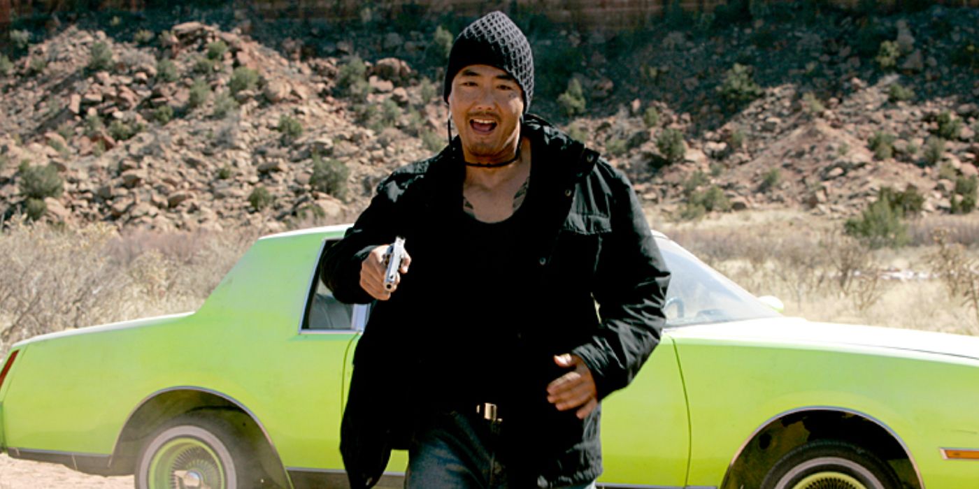 Emilio in front of a green car in Breaking Bad