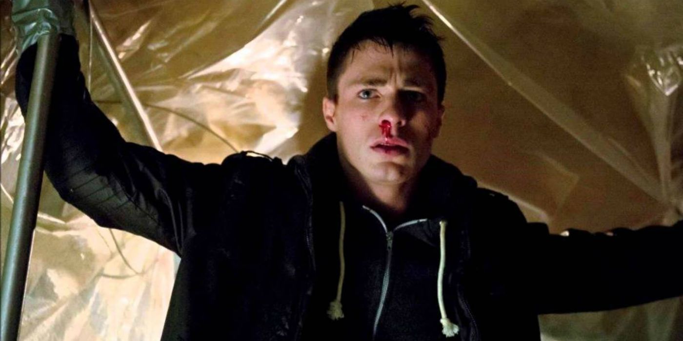 Roy Harper beaten up with his arms raised in Arrow