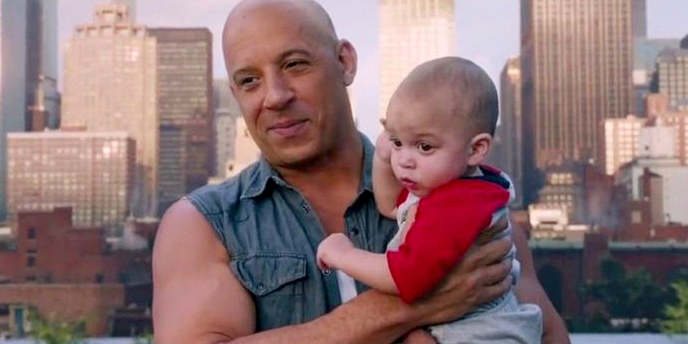 Dom holds his son Brian in Fate of the Furious