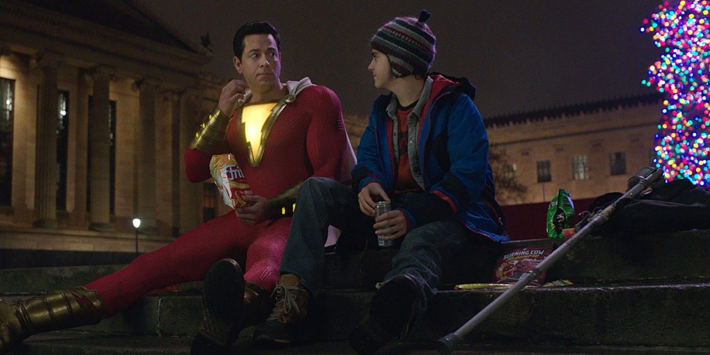 Shazam and Freddy talking while sitting in some steps in Shazam!