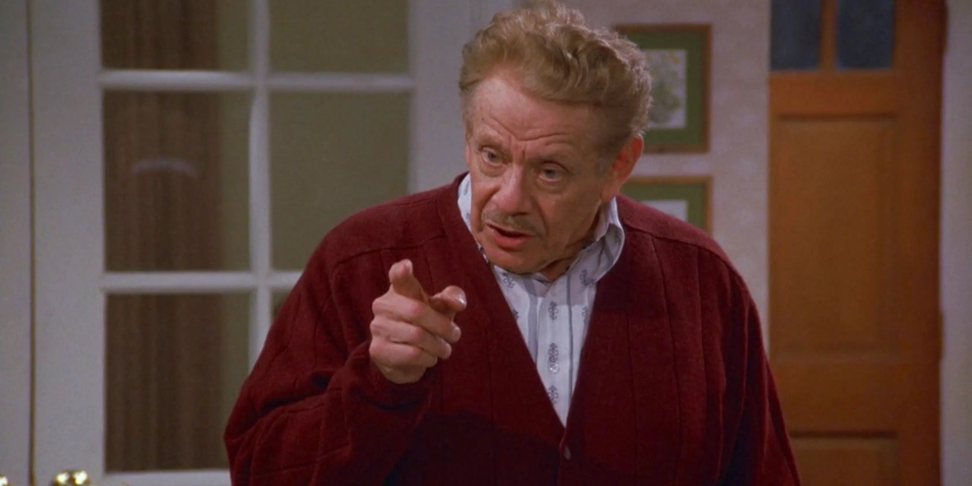 Frank Costanza talks sternly and points his finger in Seinfeld.
