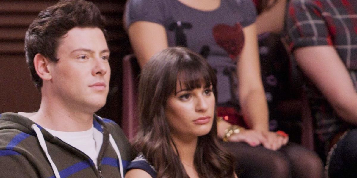 Finn sits with Rachel in the choir room on Glee.