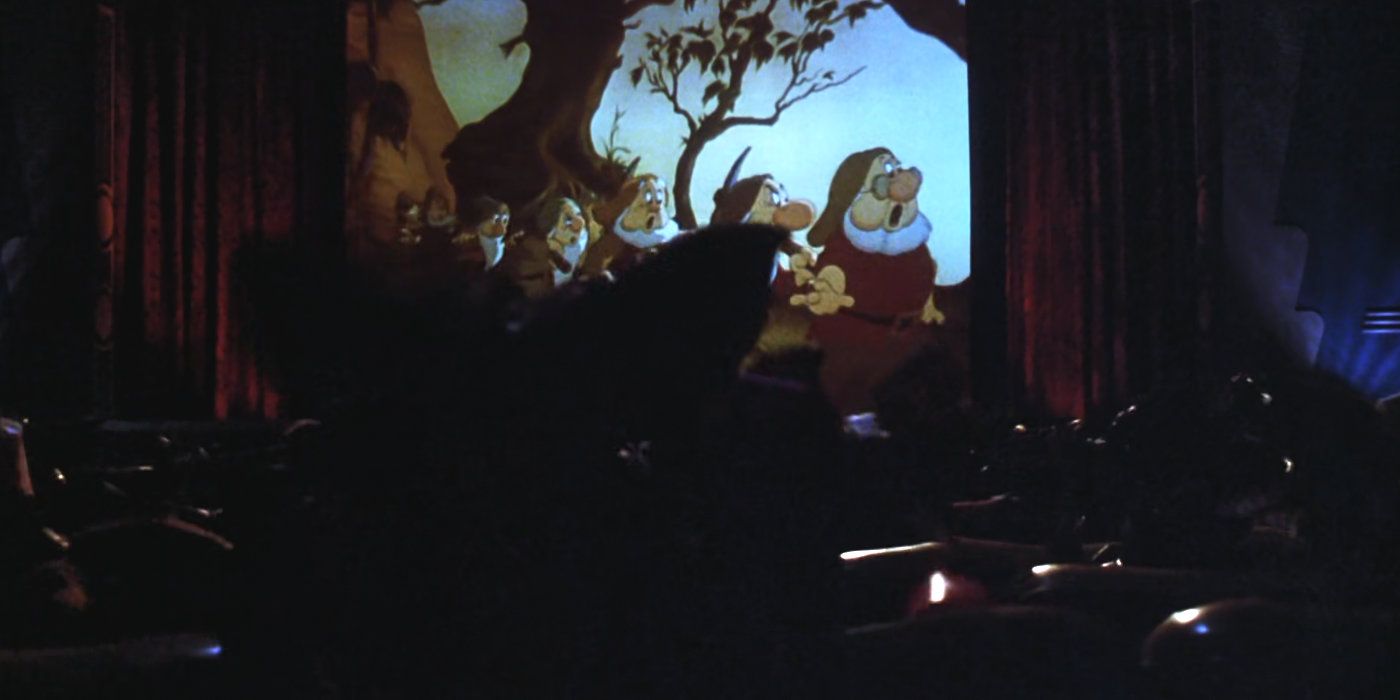 The Gremlins watch Snow White in the theater.