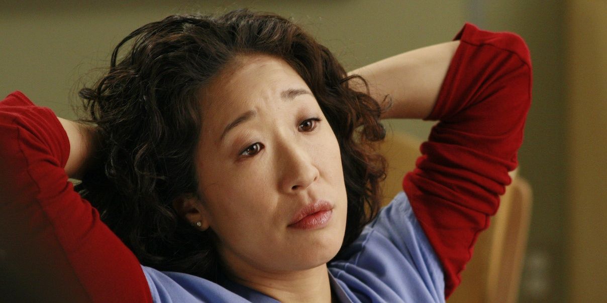 Cristina Yang puts her hands behind her head and leans back in Grey's Anatomy.