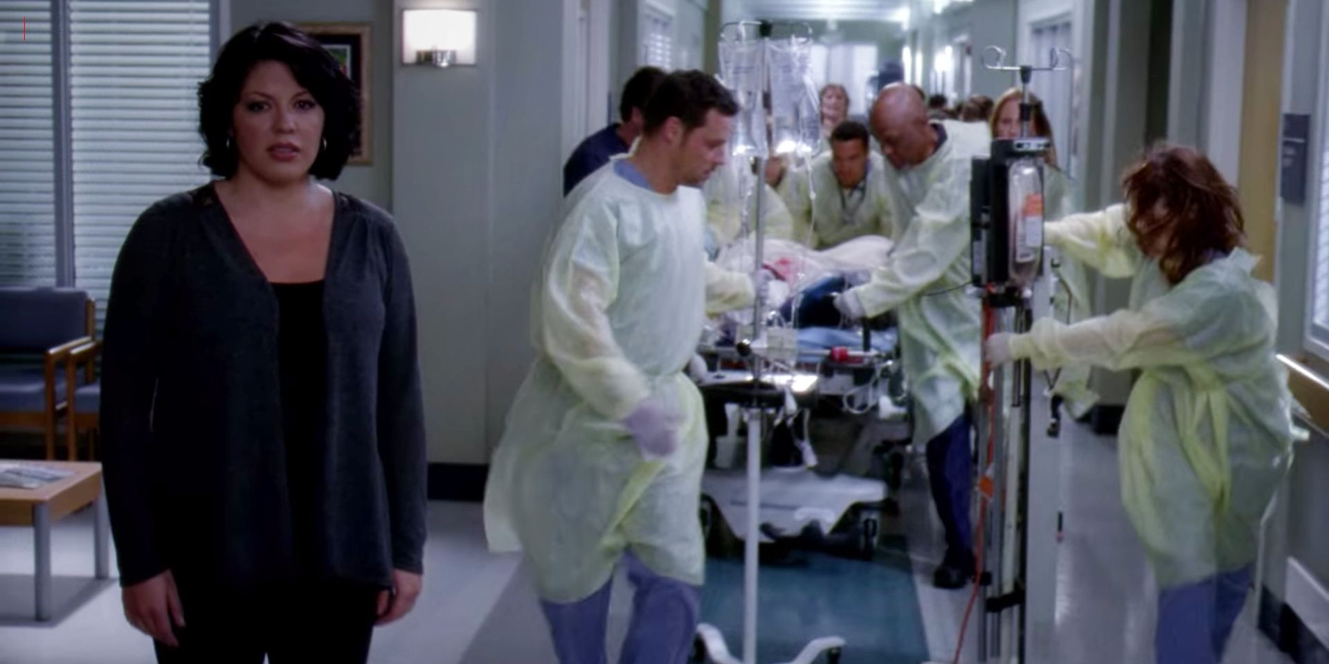 Callie singing as surgeons wheel a patient's gurney through the hospital